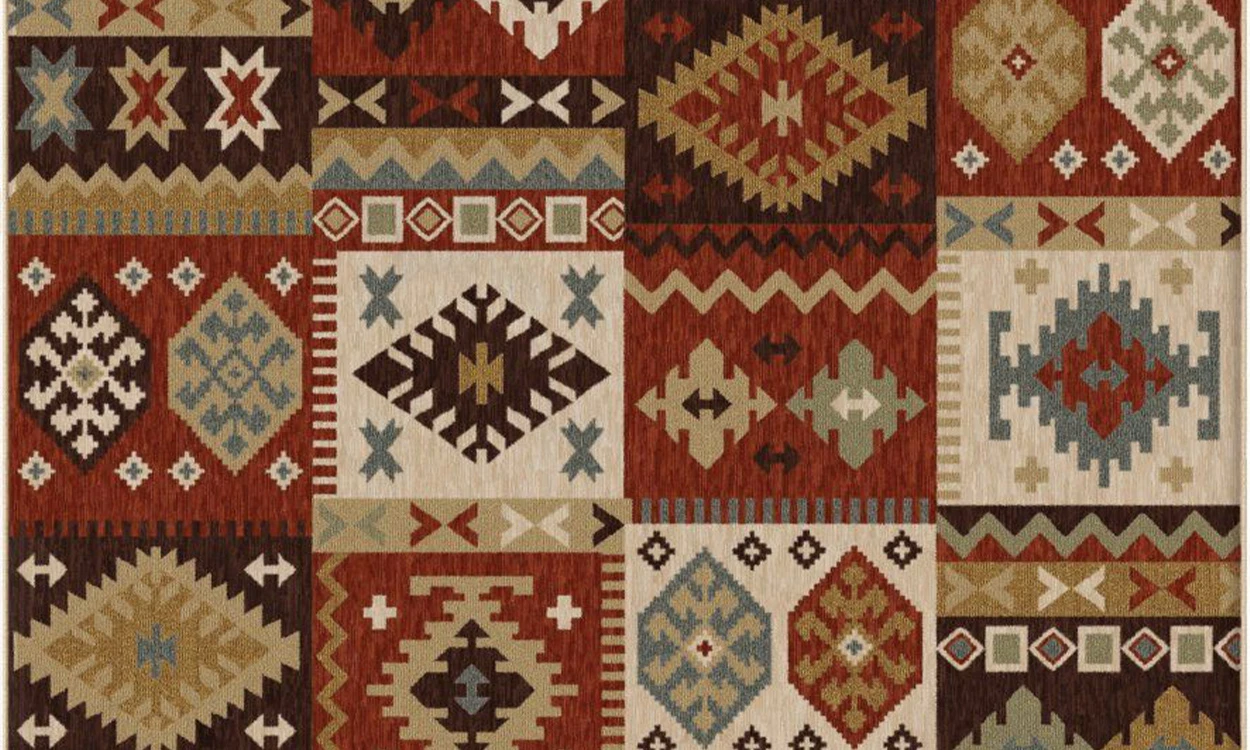 Traditional Berber rug with protective symbols including eye motifs and geometric patterns arranged to create spiritual protection