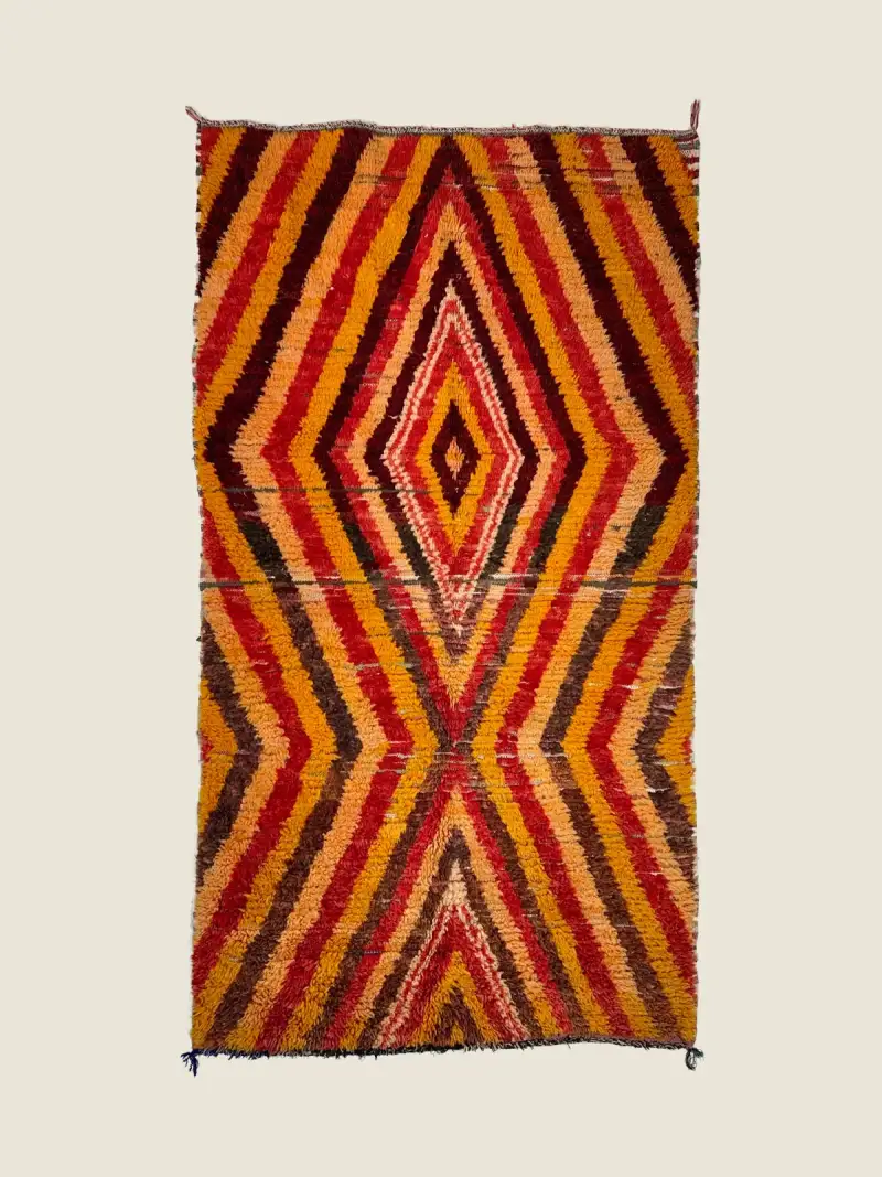 Vintage Beni M'guild rug 124×226cm, handwoven tribal pattern in vibrant red, orange, and beige.