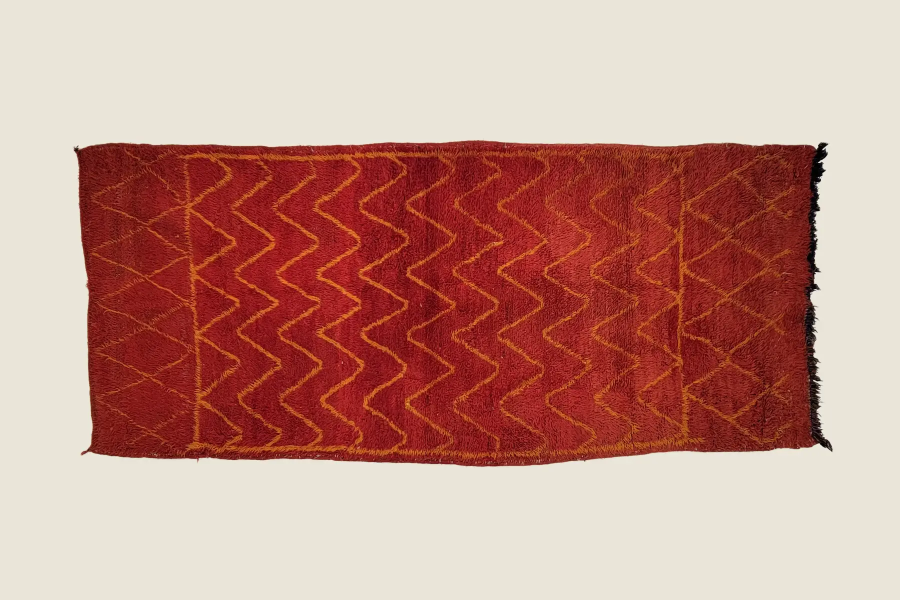 Beni M'Guild hand-knotted texture detail showing deep brick red wool and traditional weaving craftsmanship