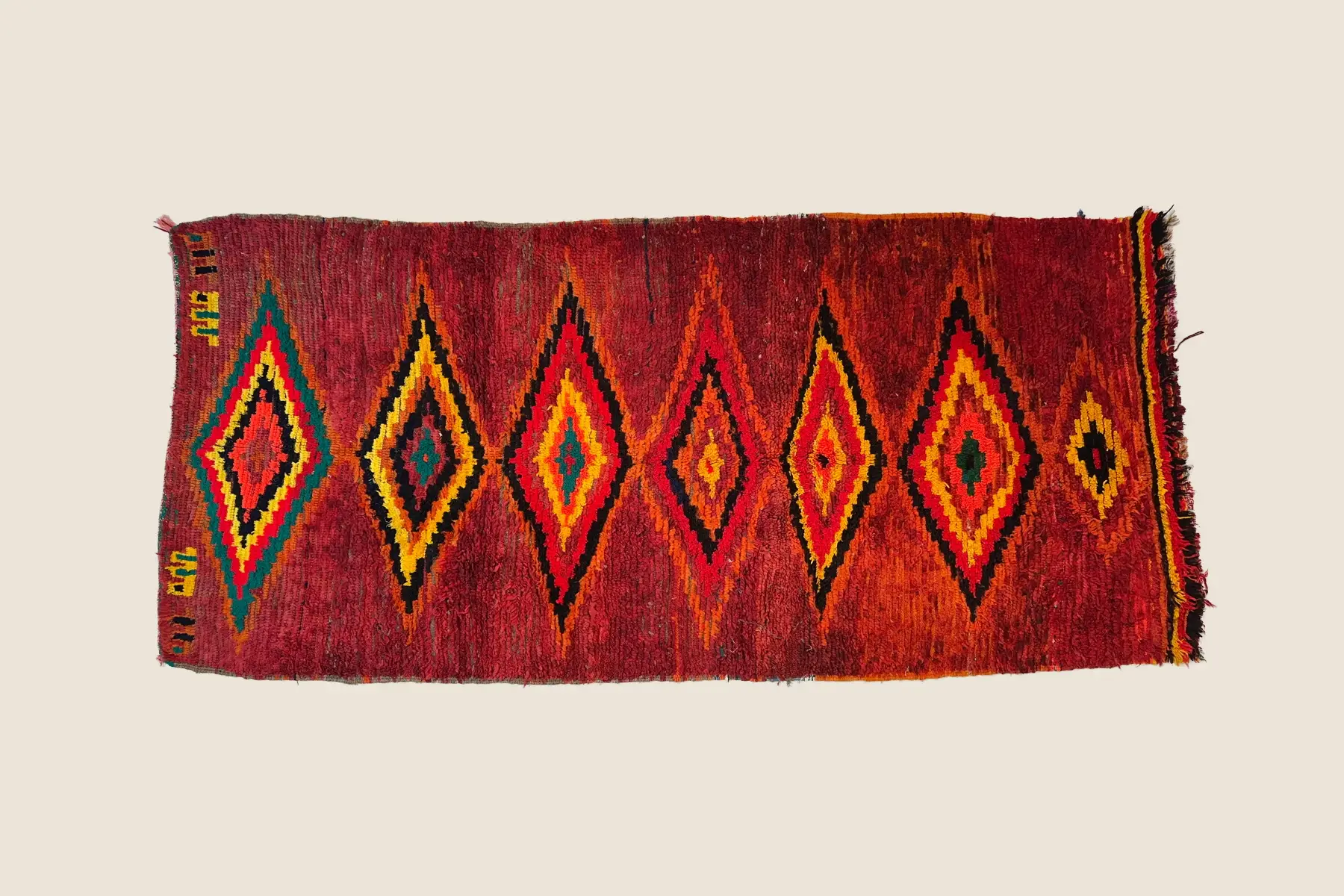 Beni M'Guild rug texture detail showing deep teal and vivid red hand-spun wool weaving craftsmanship