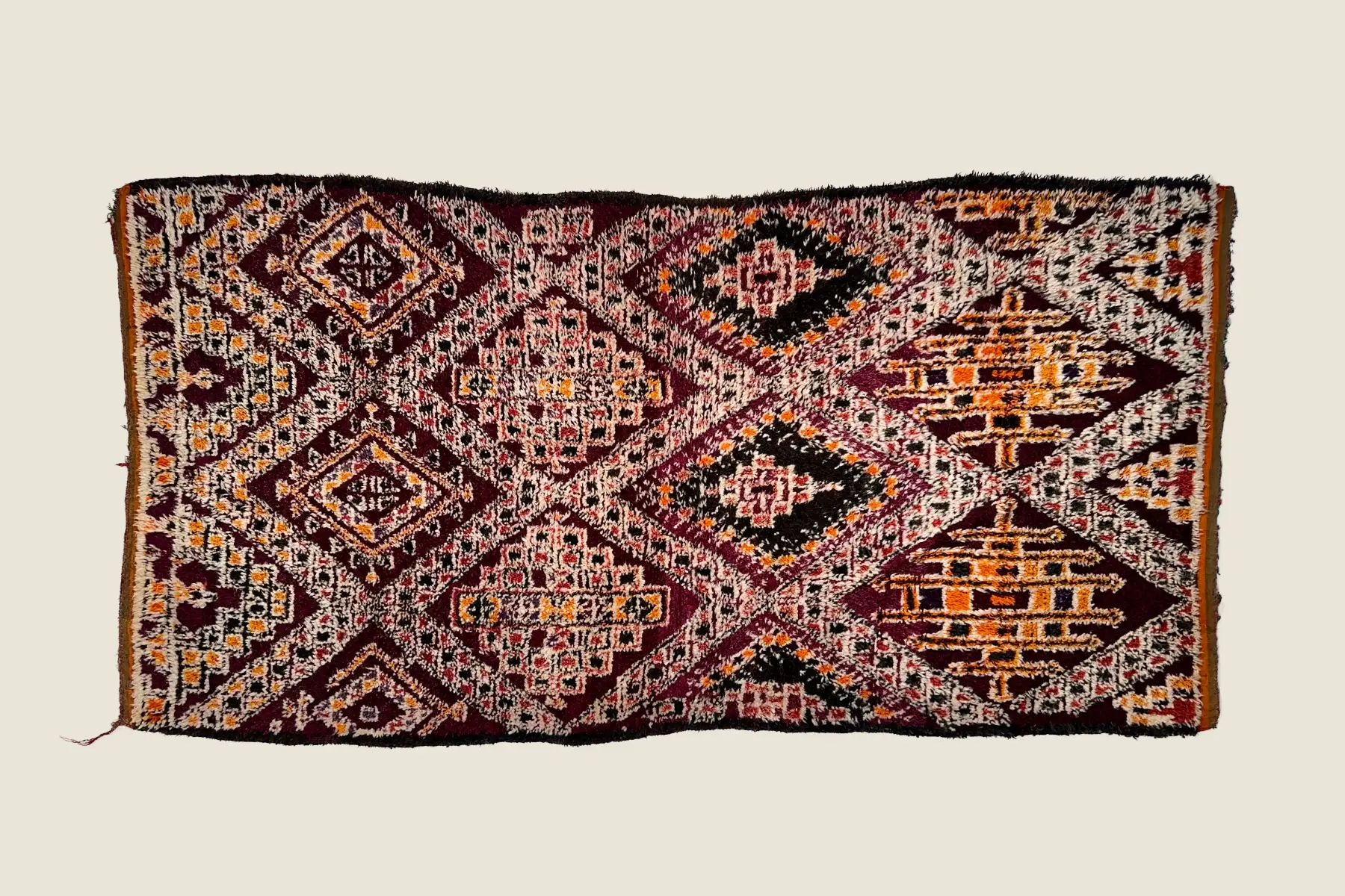 Beni M'Guild rug's vibrant orange and plum pile texture showing hand-knotted tribal craftsmanship.