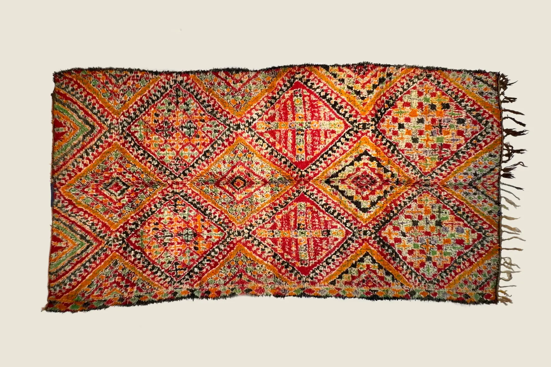 IZRIN - Beni M'Guild handwoven texture detail showing warm amber and teal wool pile - traditional Moroccan craftsmanship.