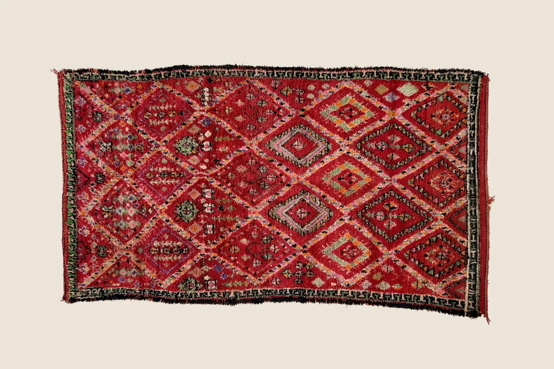 Beni M'Guild orange-red and charcoal wool detail showing hand-woven geometric motif and natural dye texture