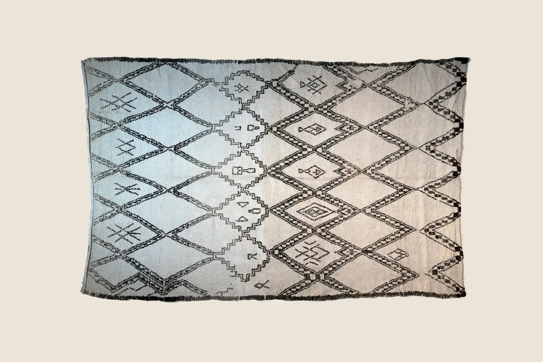 Beni Ourain high-pile texture detail showing charcoal diamond motifs and hand-knotted craftsmanship