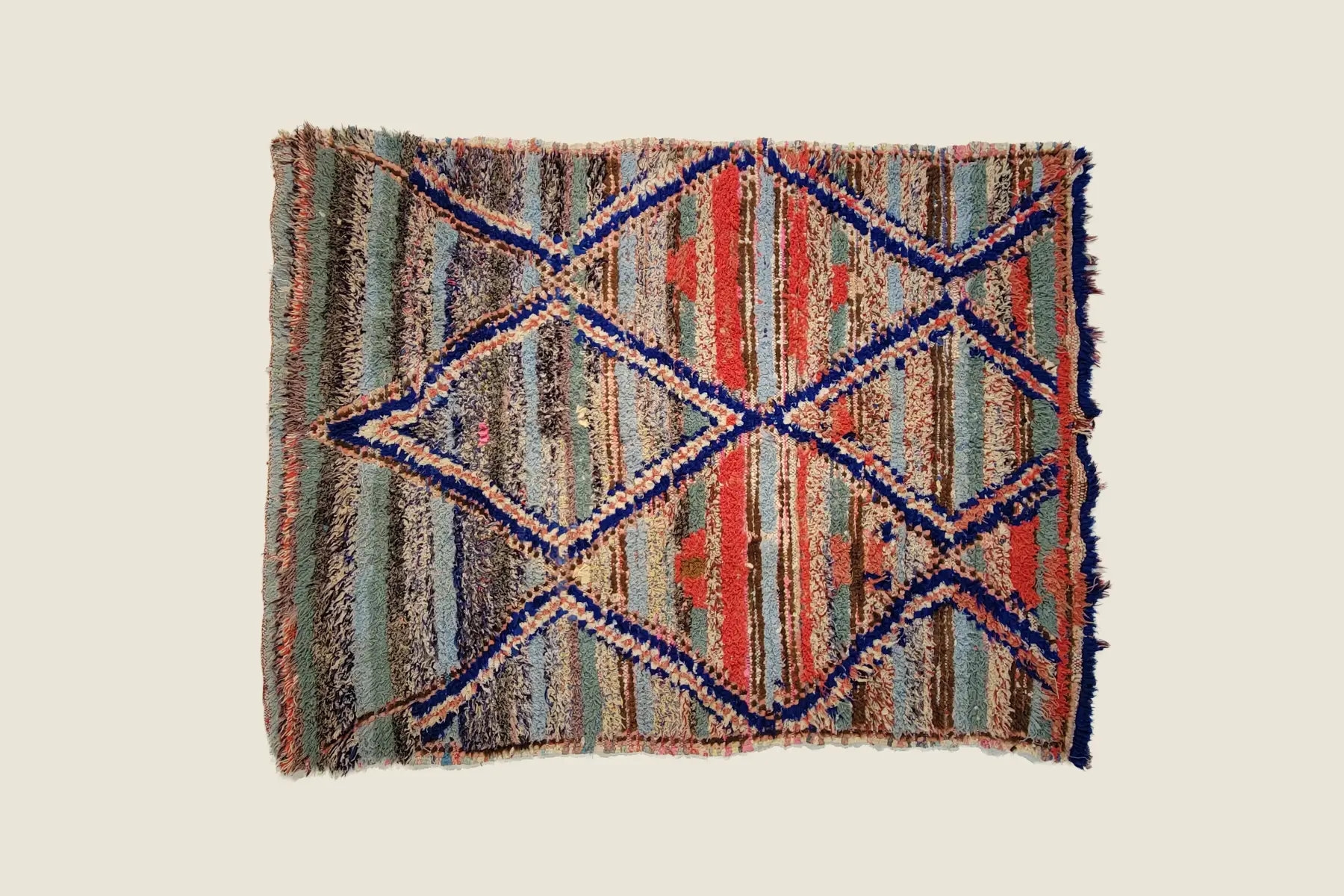 Boucherouite recycled textile detail showing deep crimson, blue, and gray-green knotting technique