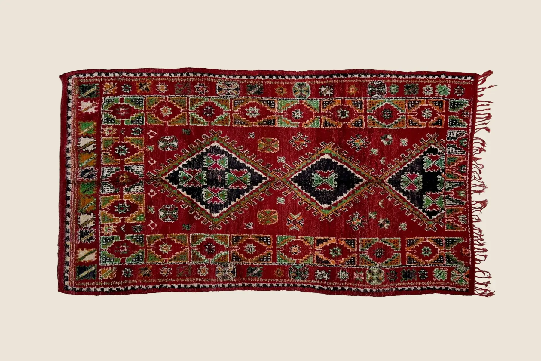 Boujad rug deep crimson wool texture showing hand-knotted pile and natural dye variations in geometric motif