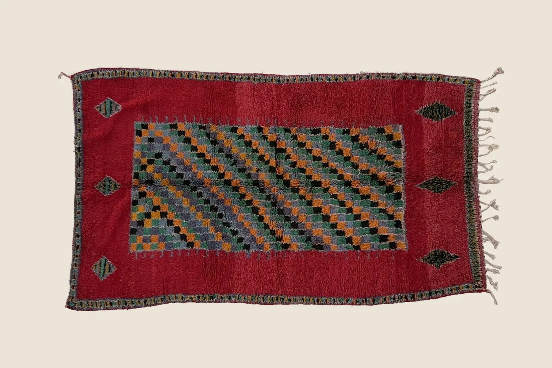 Boujad rug detail showing vivid red and warm gray hand-knotted wool texture with geometric motif craftsmanship