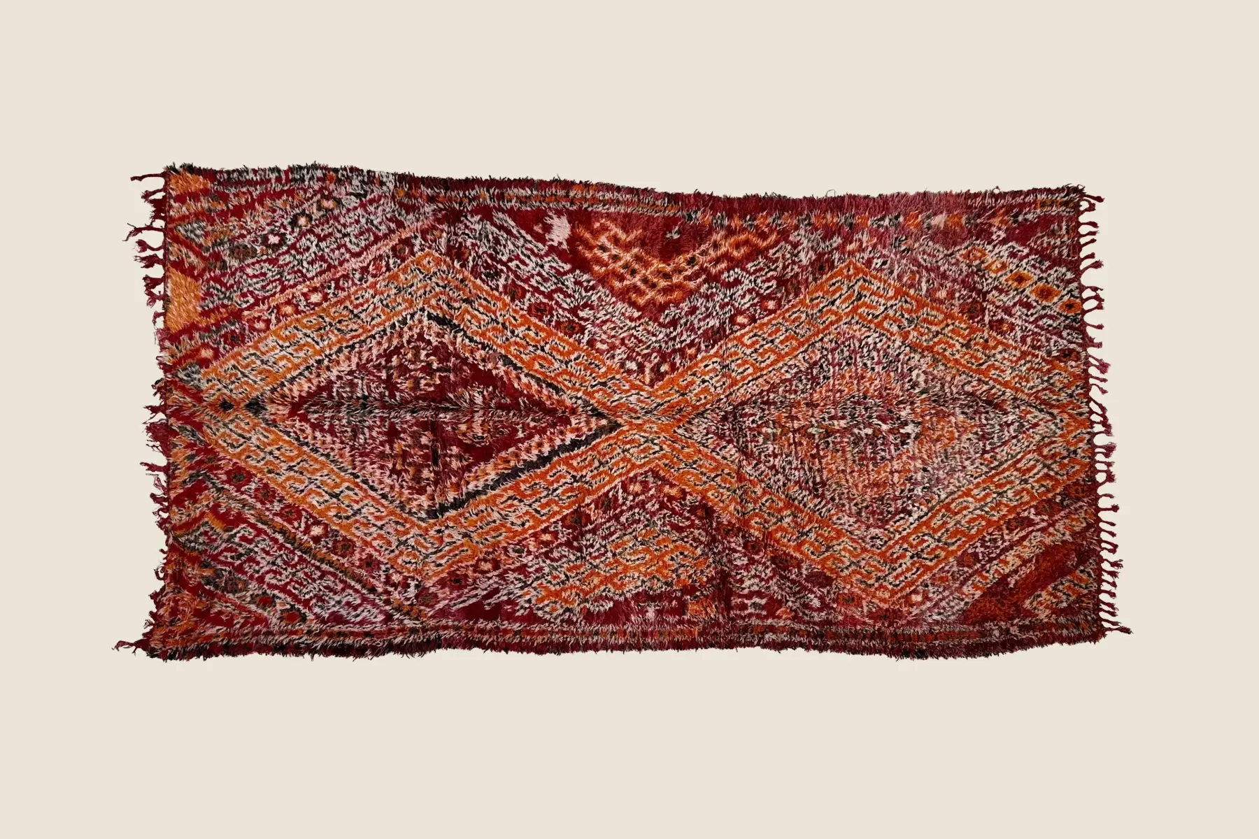 Marmoucha rug texture detail showing crimson, orange, beige, and gray hand-knotted wool craftsmanship