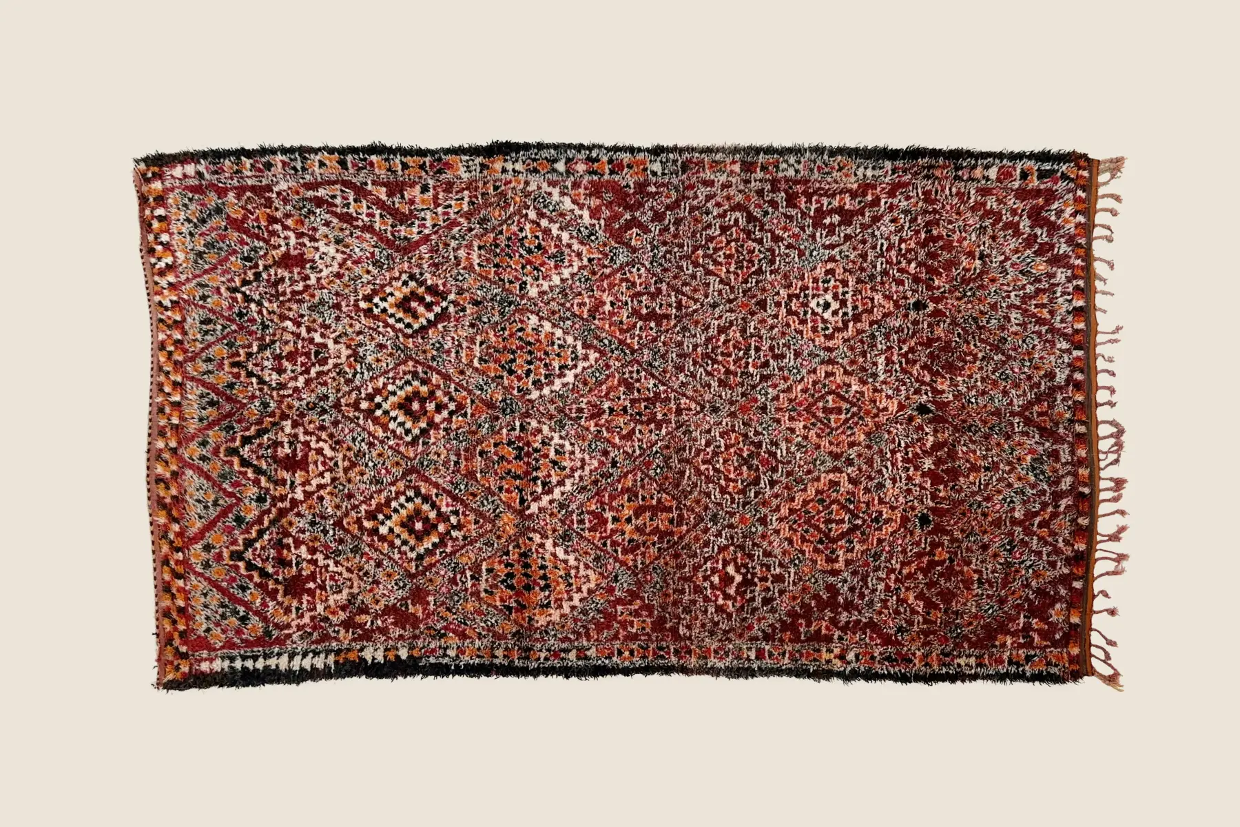 Marmoucha handwoven wool detail showing tight weave texture and dark red, warm orange color variations