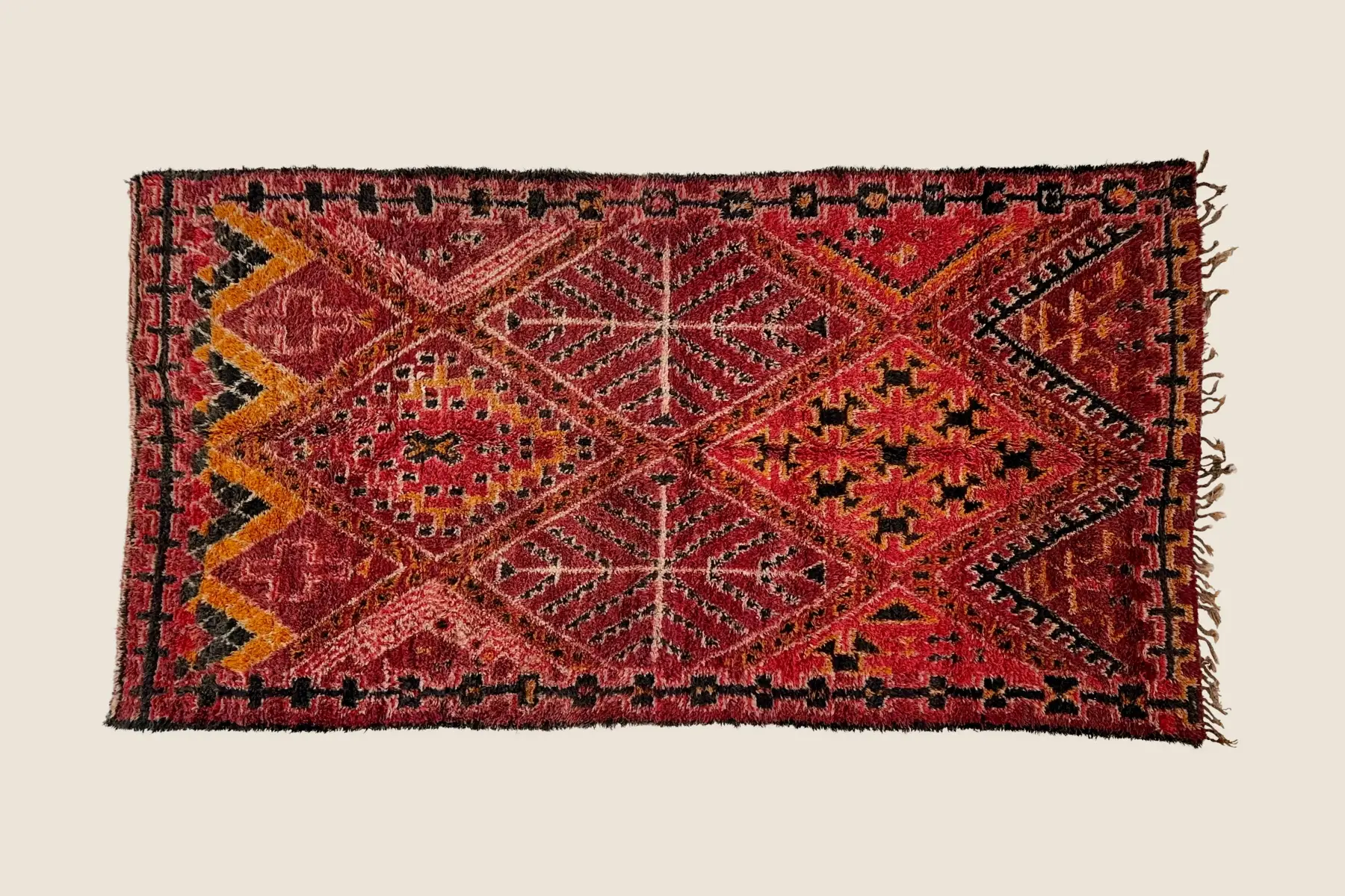 Marmoucha hand-knotted wool detail showing medium red and warm orange-brown pile texture with beige accents