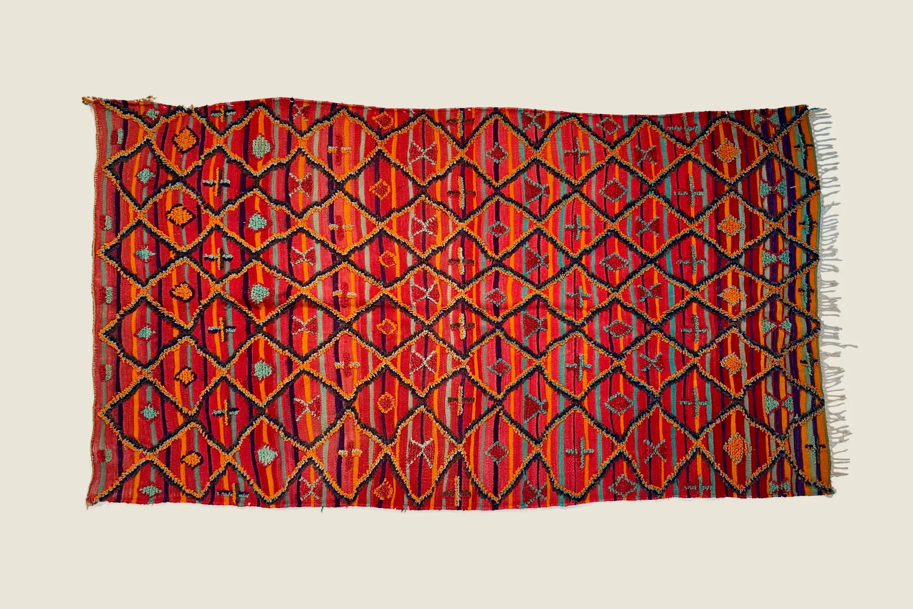 Talsint rug's deep crimson wool texture showing hand-tufted craftsmanship and vibrant color blend.