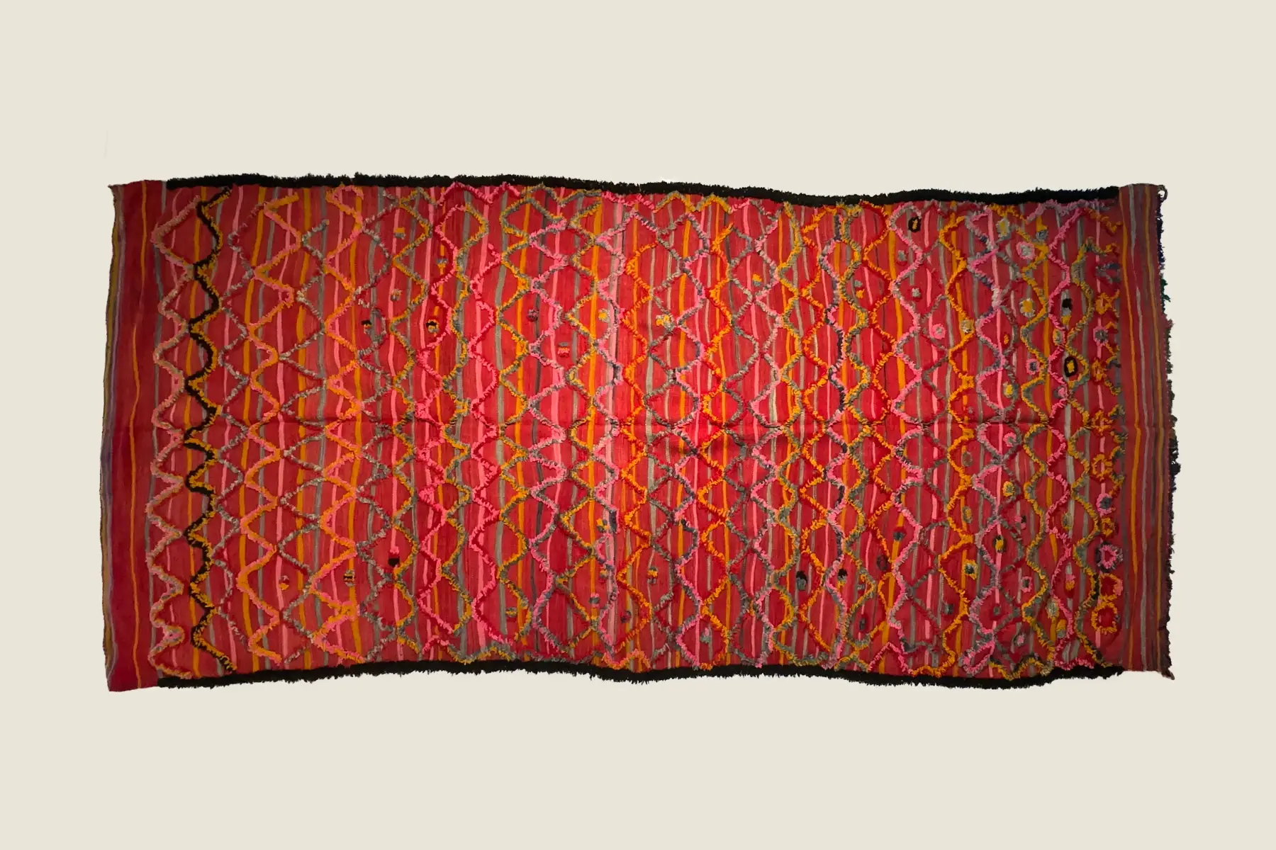 Talsint rug geometric motif detail showing precise black and saffron gold hand-weaving technique.