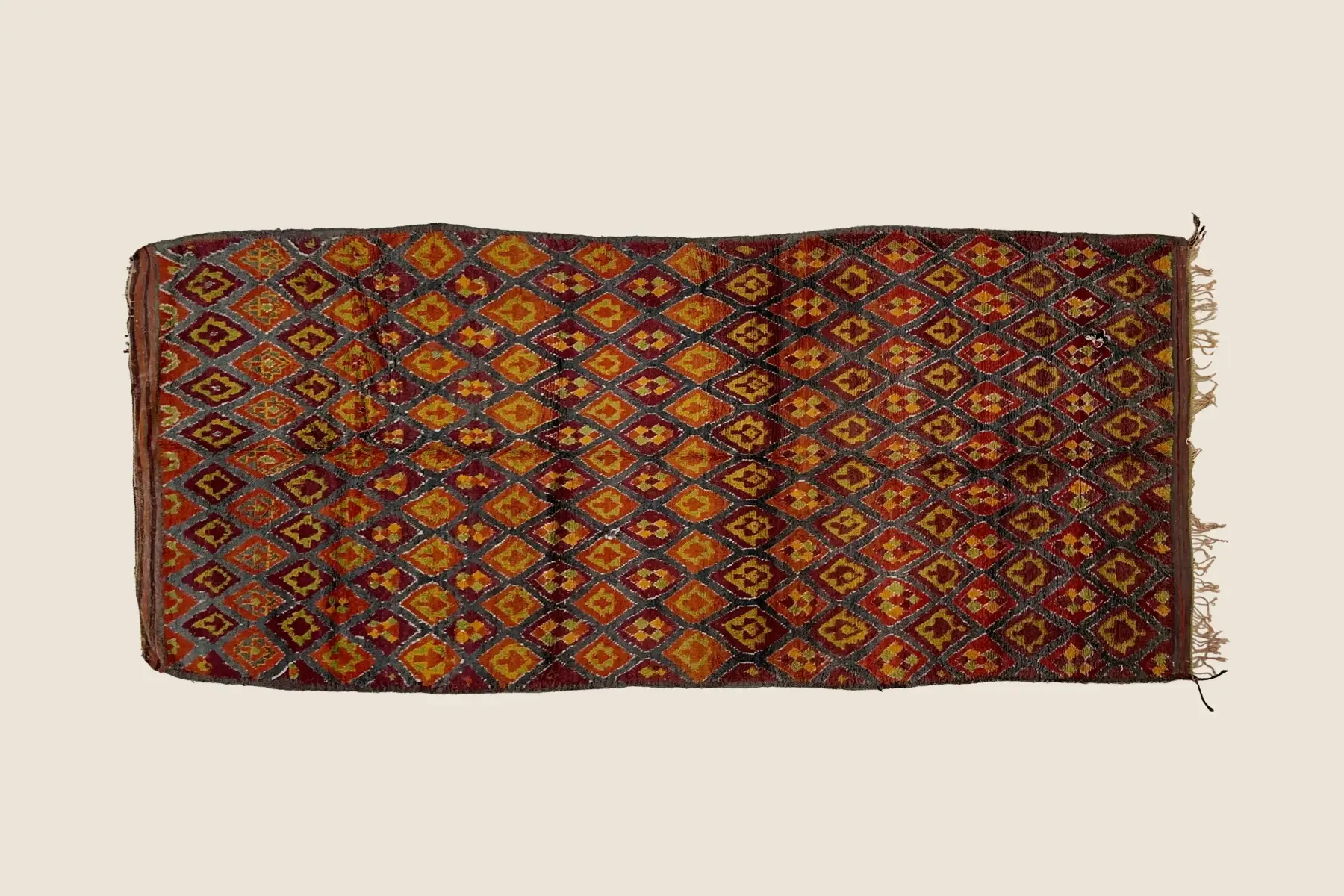 Talsint rug texture detail showing hand-knotted wool pile with olive, golden, and teal color variations