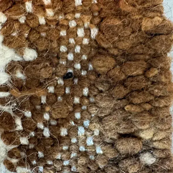 Minimalist diamond rug in a medium warm brown