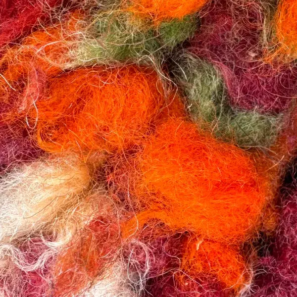 A color swatch labeled Warm Rust Orange from the orange family, shown with the Beni M'guild Rug in Rose