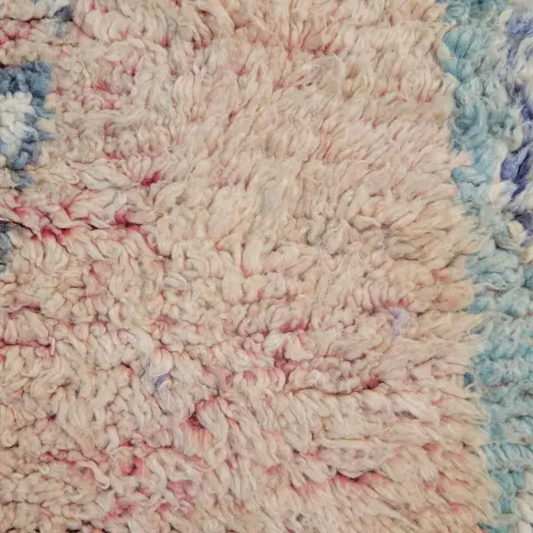 Minimalist rug in a light warm beige with subtle red undertones.