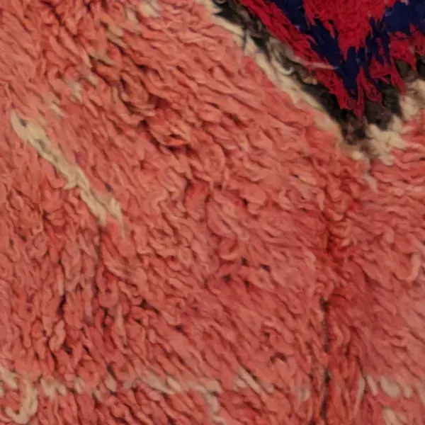 Red rug with diamond symbols in a terracotta red color.