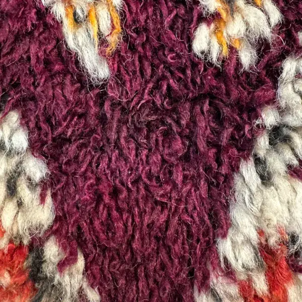 Dark pink diamond pattern on a maroon background.