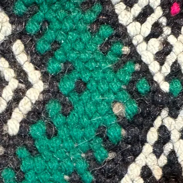 A teal green kilim rug swatch with a blue color family.