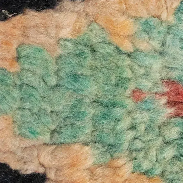 Minimalist diamond rug in muted sage green.