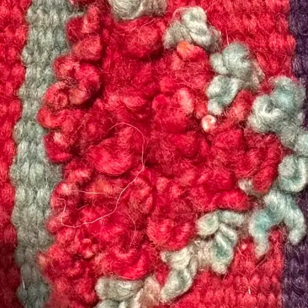 A deep crimson red diamond symbol.